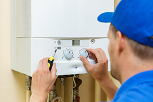 Man fixing the boiler after using the Boiler Guide