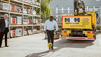 Martin Tyler with Jimmy Floyd Hasselbaink kicking a football at MKM Aldershot opening day