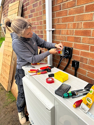 Image of a lady electrician outside using various tools - Electrical NVQ Adult Trainee Electrical Training Course to train to become a fully qualified Electrician