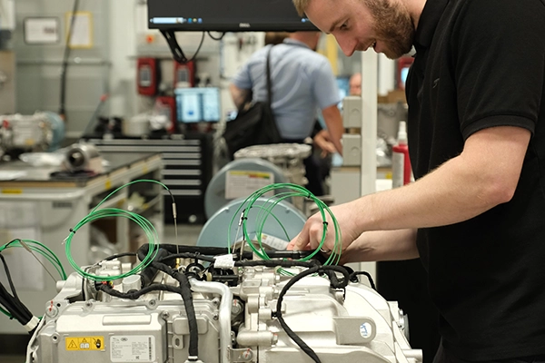 Man working at a machine in Jaguar Landrover facility - recruitment for 250 electrification engineers jobs