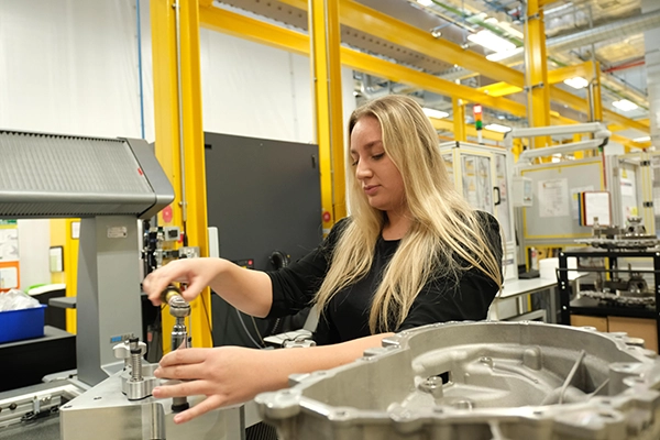 Lady working at a machine in Jaguar Landrover facility - recruitment for 250 electrification engineers jobs