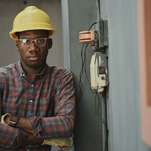 electrician stood by wires - expert tips for electricians on how to handle business crises