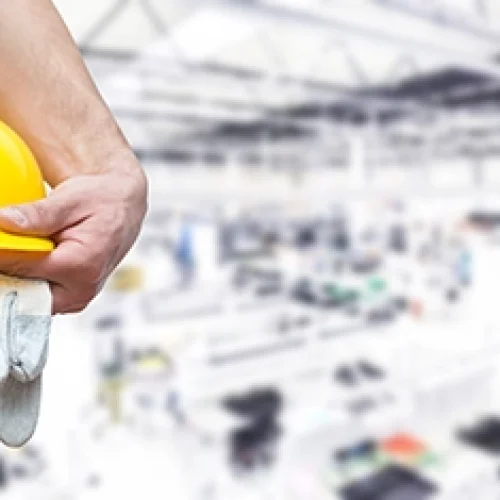 Workwear, man holding a safety helment